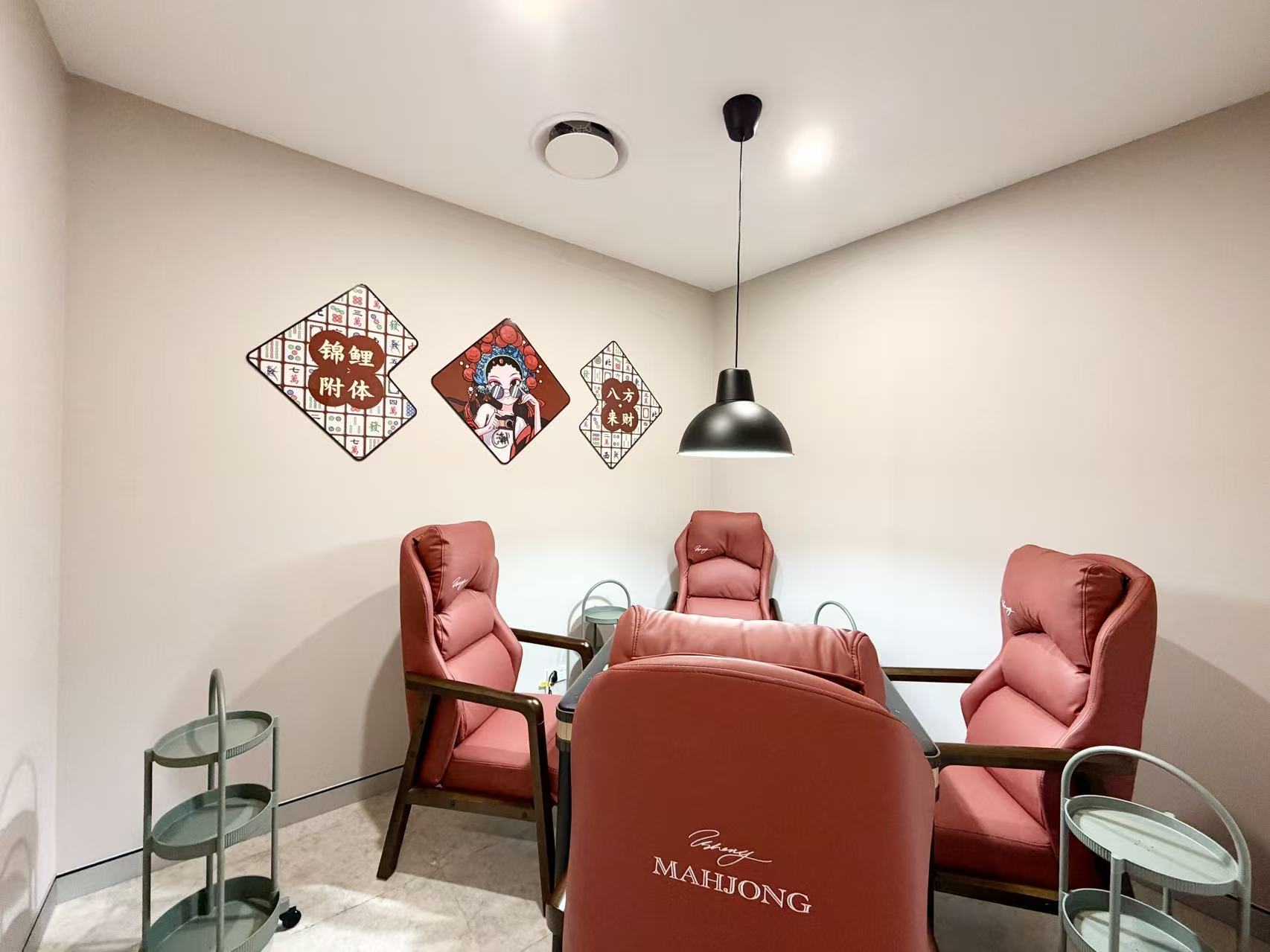Another angle of the mahjong room: cushioned high-back chairs and storage trolleys